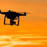 drone flying through orange sky