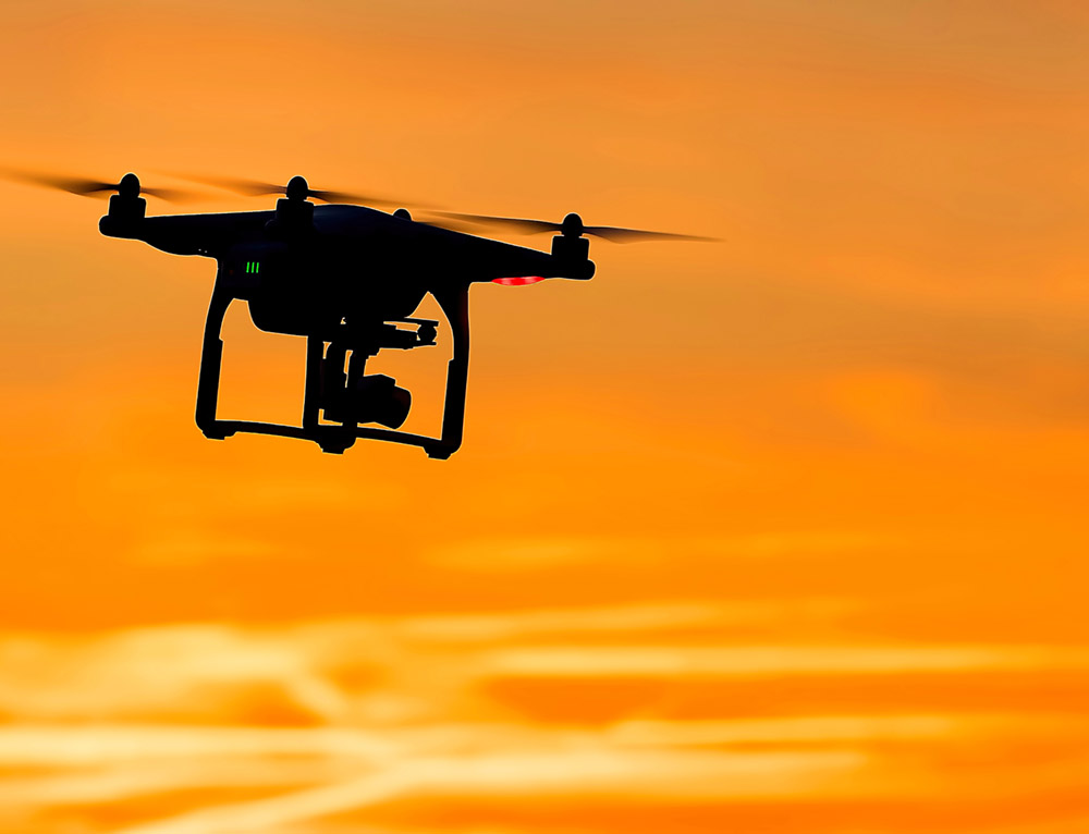drone flying through orange sky